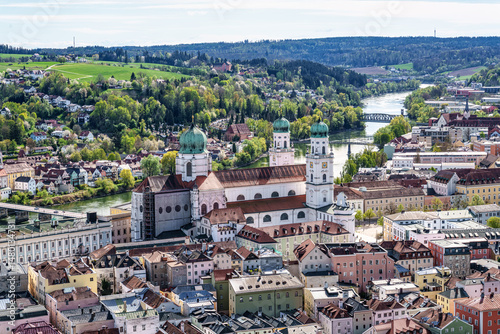 St. Stephans cathedral in Passau, Germany is an old white church with green metal domes on top of the towers