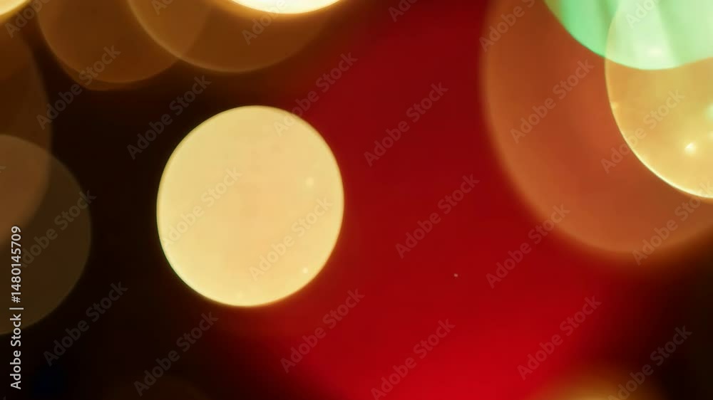 Close up of a microscope and wine glass with glowing red and yellow bokeh lights during a bright holiday celebration