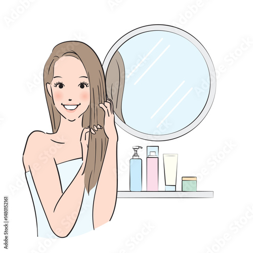 丁寧にヘアケアをするロングヘアの女性