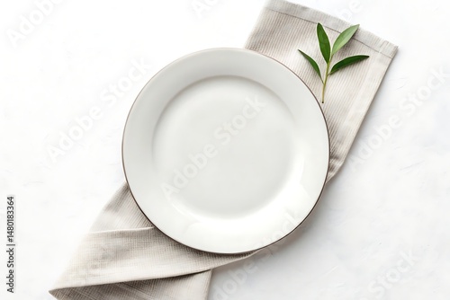 Empty white plate with napkin – minimalist kitchen or dining scene