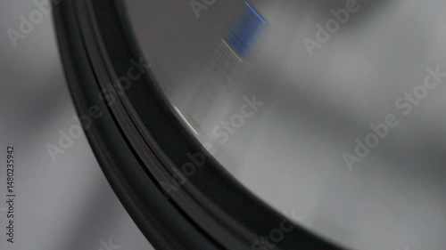 A spinning bicycle wheel shows the spokes and tire in motion, creating a blurred effect due to speed. It symbolizes movement and progress