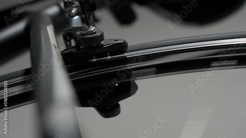Close-up shot of a bicycle brake system with the wheel spinning in the background. The mechanism remains still while the rim or disc moves, ideal for illustrating precision, engineering