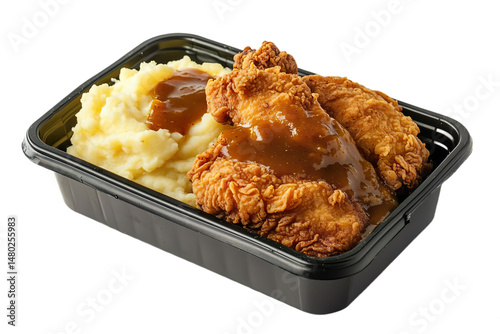 Crispy fried chicken with a serving of mashed potatoes topped with rich gravy, presented in a black plastic rectangular parcel box isolated on transparent background