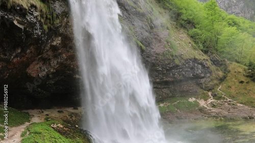 expansive waterfall featuring a significant volume of cool fresh water powerfully cascading downwards creating a dynamic and visually impressive display of natural force 