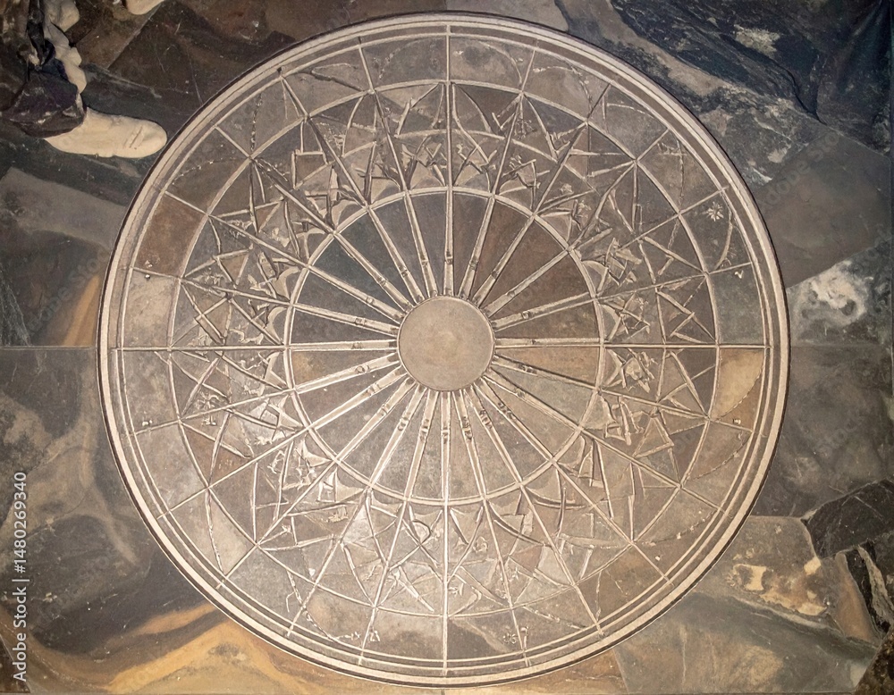 Naklejka premium Participants gather around a beautiful stone compass to honor the summer solstice festivities.