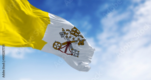 Flag of Vatican City waving in the wind on a clear day
