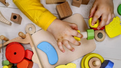 Child playing with colorful wooden educational toys, hands-on learning and motor skills development, vibrant playful activity, early childhood education concept, preschool resources, parenting content