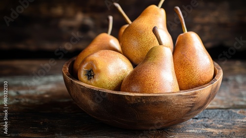 A rustic wooden bowl filled with golden-brown Bosc pears
