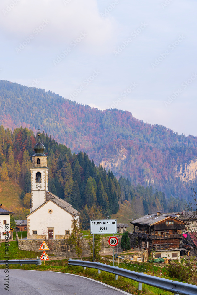 Fototapeta premium Sauris di Sotto road sign welcoming visitors to the charming Italian village in Friuli Venezia Giulia