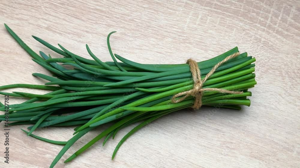 Fresh chives bunches tied with twine on table