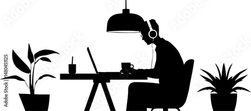 Man wearing headphones working on laptop at a desk with plants  and drink coffee