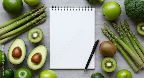 Green Fruits And Vegetables Surrounding A Notebook For Meal Planning