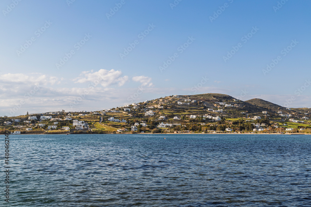 Fototapeta premium View of houses on the hill in Krotiri village by the Aegean Sea near Paroikia (Parikia) on Paros island in Greece on a sunny day.
