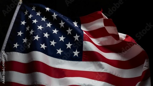 American flag waving in the wind against a dark background  