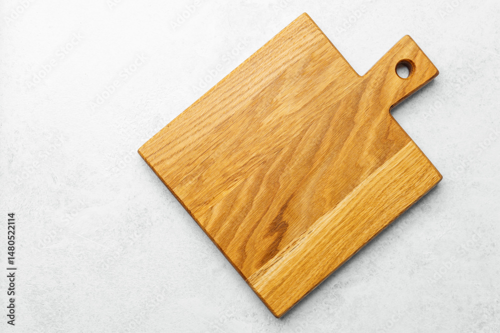Fototapeta premium Wooden cutting board on light surface showcasing craftsmanship and design