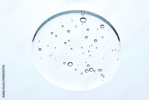 A drop of micellar cleansing gel for face wash on a blue background.