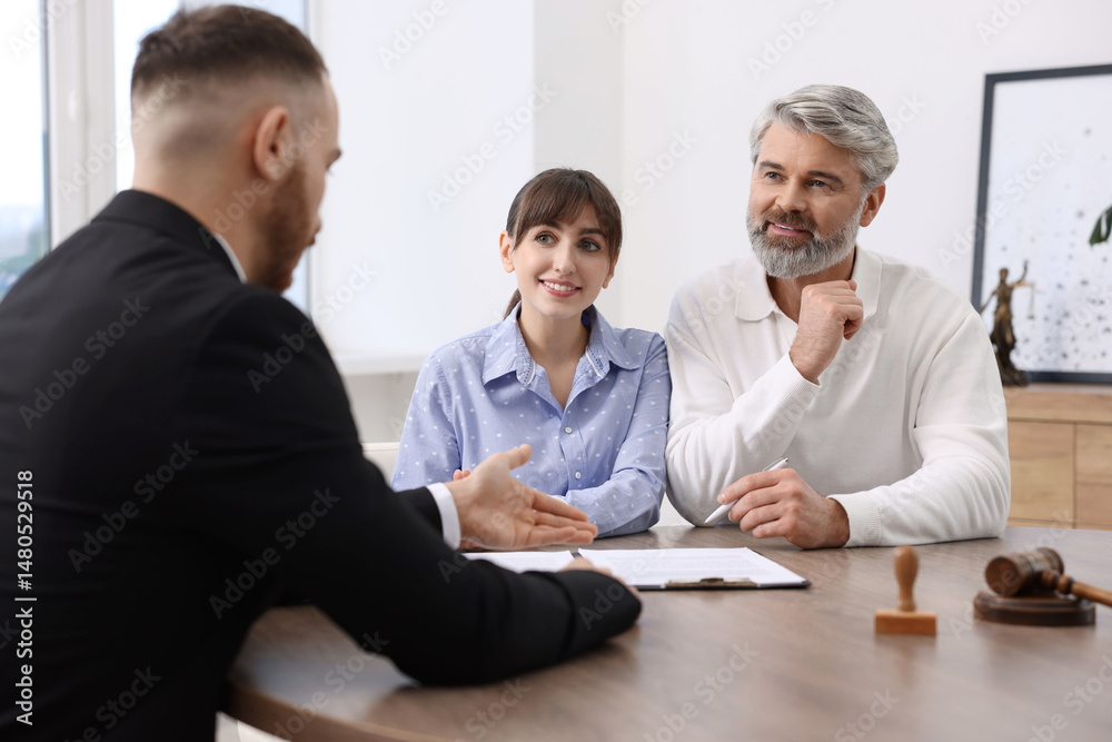 Fototapeta premium Couple having meeting with professional notary at wooden desk indoors
