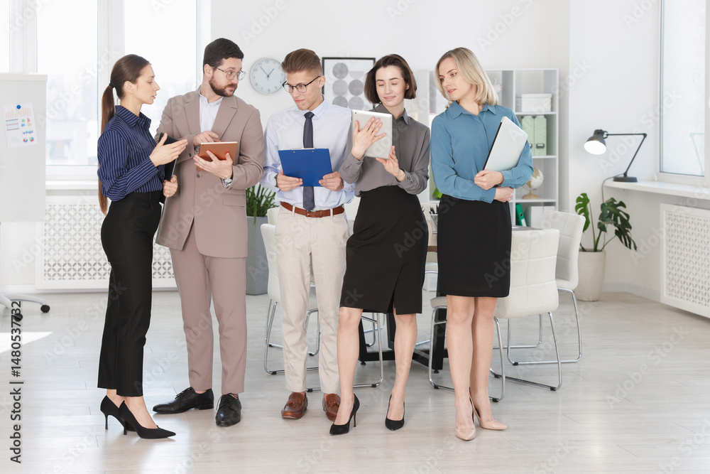 Fototapeta premium Group of confident coworkers in formal clothes indoors