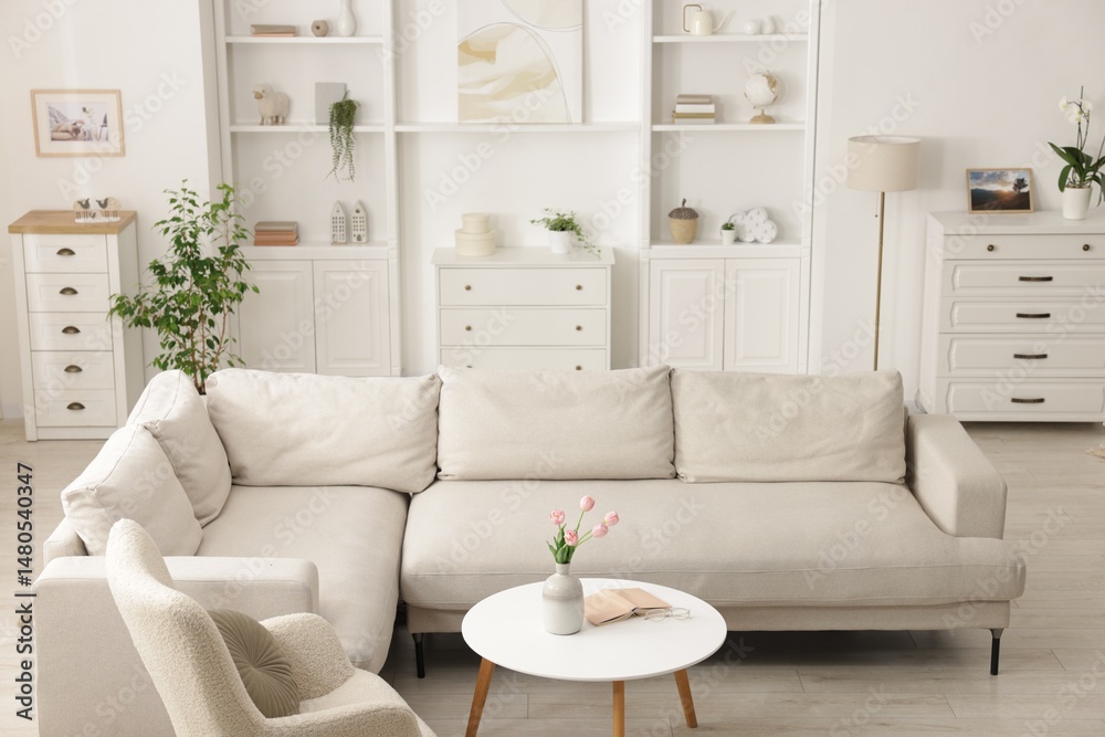 Obraz premium Comfortable sofa, armchair and side table in living room