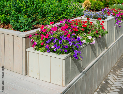 Multi-tiered decorative flowerbed made of wooden planks