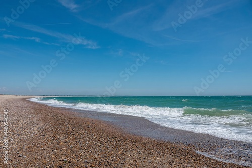 beautiful deserted beach at Selsey West Sussex England with blue sky in the background