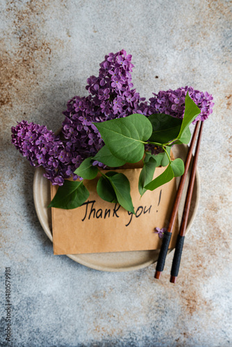 Thank you card with lilacs and chopsticks on plate photo