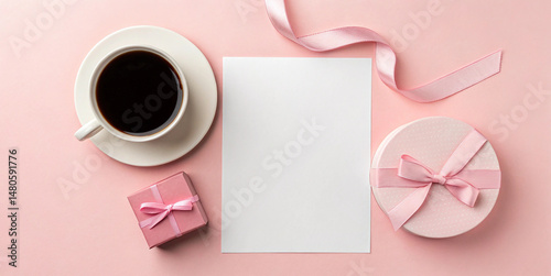Flat lay of white paper and coffee cup on pastel pink background
