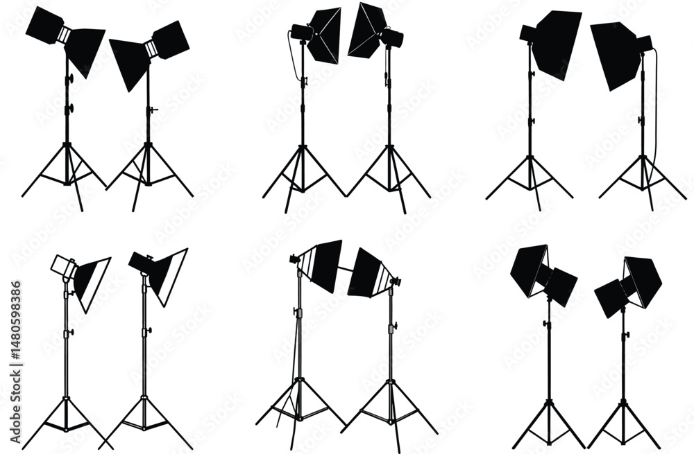 A black silhouette of a photographer with a camera on a tripod stands in a studio with professional lighting equipment