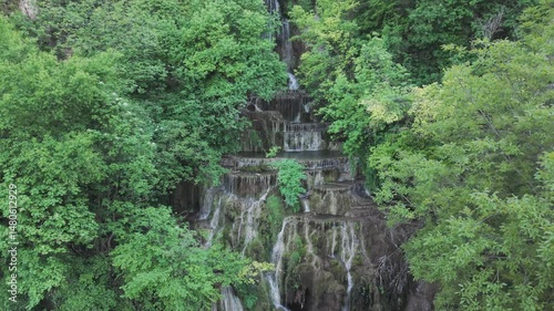 Spectacular drone shot of a forest waterfall photographed at the Krushuna Waterfalls located in Bulgaria