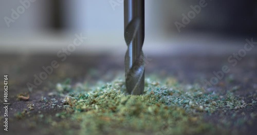 Drill breaks through chipboard close-up