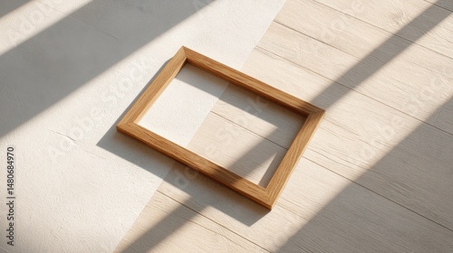 Empty wooden frame on oak floor, morning light casting shadows. Minimalism and space for imagination.