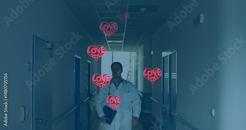 Image of hearts with love over caucasian doctor walking on corridor