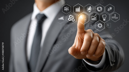 Businessman in suit interacting with futuristic virtual interface using gesture-based technology for data analysis and innovation