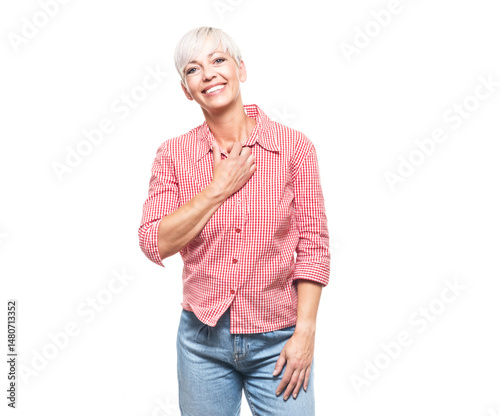 Ecstatic adult woman keep hand on chest, isolated on white background. Pleased pretty middle aged woman.