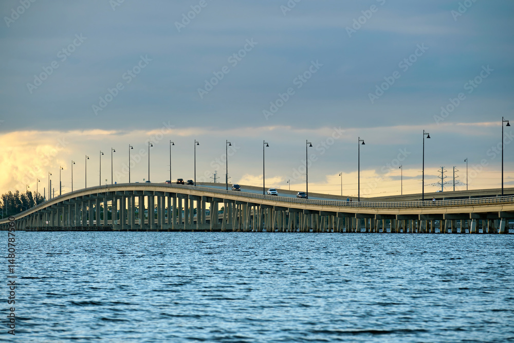 Obraz premium Barron Collier Bridge and Gilchrist Bridge in Florida with moving traffic. Transportation infrastructure in Charlotte County connecting Punta Gorda and Port Charlotte over Peace River