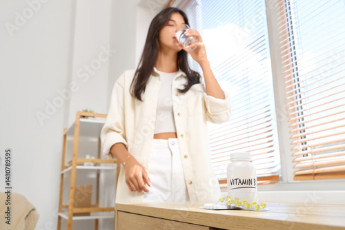 Young woman with glass of w...