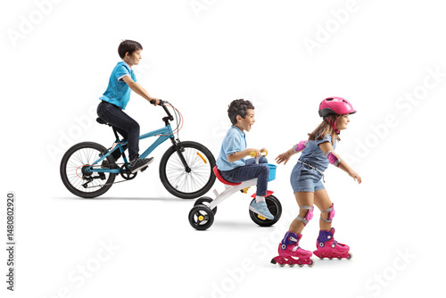 Boys on bicycles and a girl riding rollerblades with helmet, knee and elbow pads