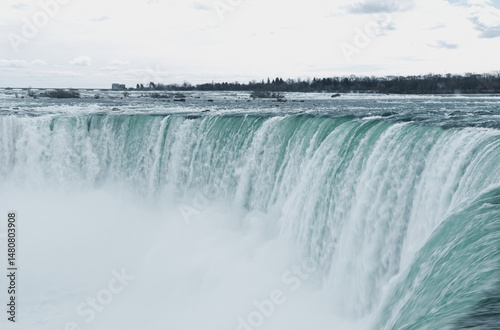 Canadian side view of Niagara Falls, Horseshoe Falls in a sunny day in Niagara Falls, Ontario, Canada. This was on a sunny spring afternoon with blue skies.