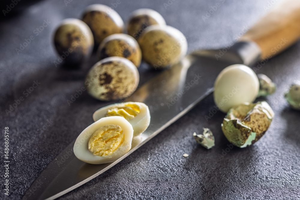 Boiled quail eggs on black table.