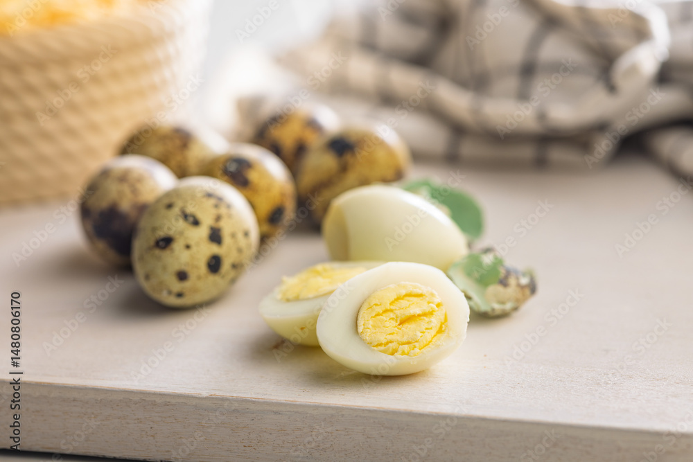 Boiled quail eggs on cutting board.