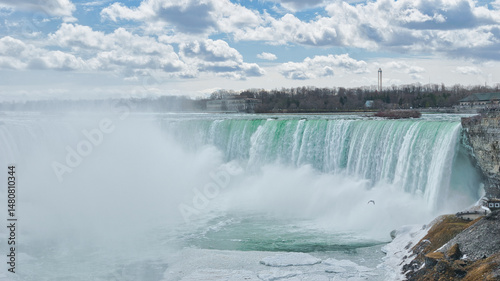 Canadian side view of Niagara Falls, Horseshoe Falls in a sunny day in Niagara Falls, Ontario, Canada. This was on a sunny spring afternoon with blue skies.