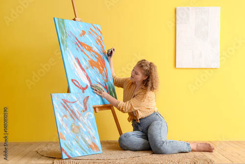 Female artist painting with...