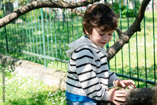 Child enjoys playing in a sunny park while exploring nature