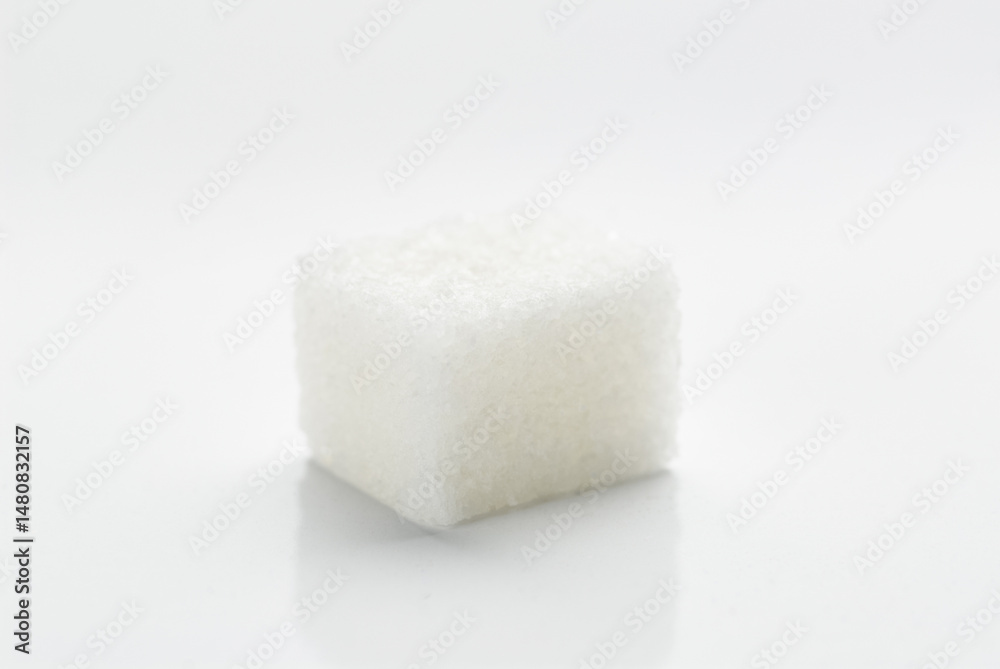 Close-Up of a Single White Sugar Cube on White Background.. Close-Up of a Single White Sugar Cube on White Background..