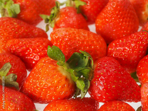 Close up of pile of strawberry. Fine fruits. White background. Tasty snack. Agriculture industry and food supply.