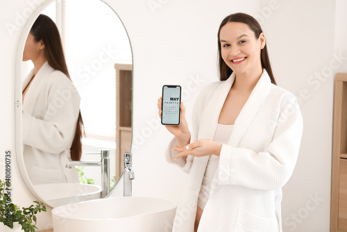 Young woman holding mobile ...