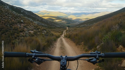Mountain biking on scenic trail through rolling hills