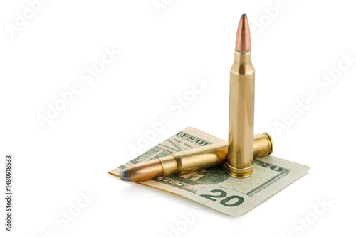 Military cartridge lies on the background of US dollars. Full depth of field.