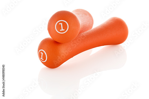 Two orange rubberized dumbbells isolated on white background. Sports equipment. Full depth of field.