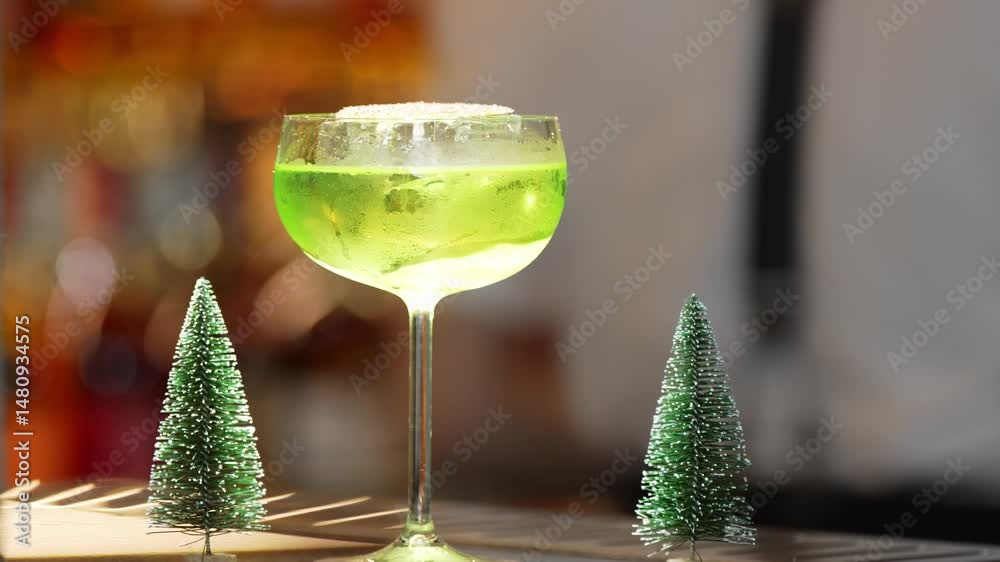 Special drink in Midori Sour cocktail with caramelized citrus slice served stylish glass on luxurious bar decorated by christmas tree neon light theme on bokeh nightclub classic background. Vinosity.